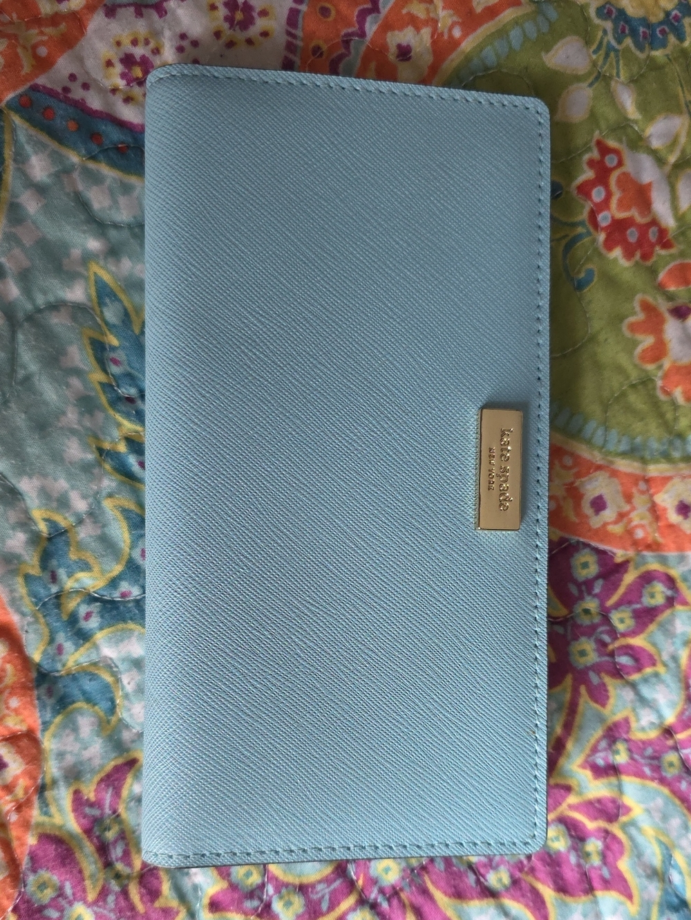 kate spade light blue with gold logo